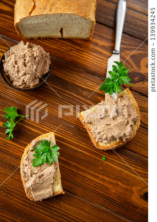 Fresh bread with creamy pate on dark wooden table Fresh bread with creamy pate on dark wooden table 139934245