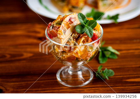 layered coffee fruit jelly dessert in glass bowl with mint 139934256