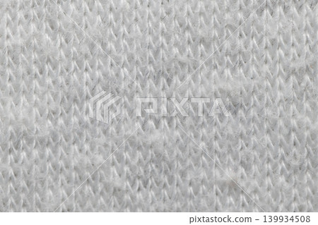 White knitted fabric texture macro warm wool clothing background White knitted fabric texture macro warm wool clothing background 139934508