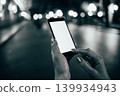 Black and white shot of hand using phone 139934943
