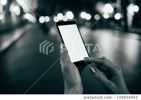 Black and white shot of hand using phone Black and white shot of hand using phone 139934943