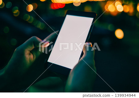 Night scene with glowing hands gripping phone Night scene with glowing hands gripping phone 139934944