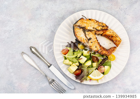 Roasted Trout Steak Served with Fresh Salad and Lemon Roasted Trout Steak Served with Fresh Salad and Lemon 139934985