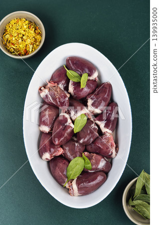 Raw turkey offal in baking dish with herbs and spices 139935000