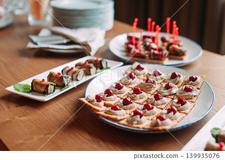 Assorted canapes and finger foods on trays for a holiday buffet Assorted canapes and finger foods on trays for a holiday buffet 139935076