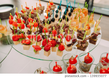 Assorted canapes and finger foods on trays for a holiday buffet Assorted canapes and finger foods on trays for a holiday buffet 139935077