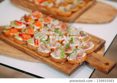 Canape on wood tray , pasty , bakery , fresh. Concept of catering at the event Canape on wood tray , pasty , bakery , fresh. Concept of catering at the event 139935083