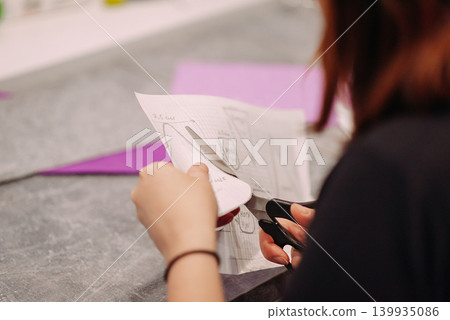 Female hands cutting paper craft at workshop Female hands cutting paper craft at workshop 139935086