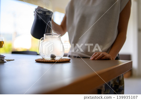 A woman who is making tea A woman who is making tea 139935107