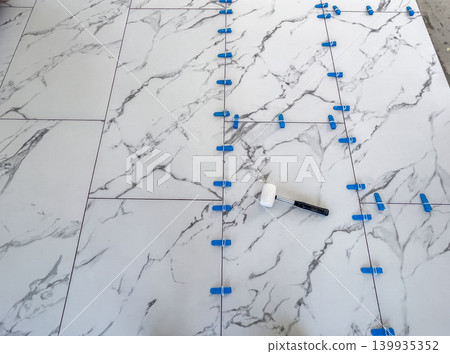 Tile laying with tools Tile laying with tools 139935352
