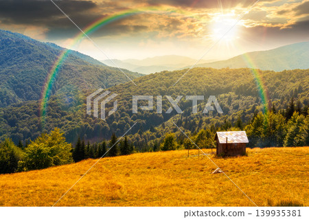 sunset over view of mountain meadow. countryside summertime landscape with beech forest on the grassy field on hill. cloudy sky. alpine background for travel through highland. weather with rainbow 139935381