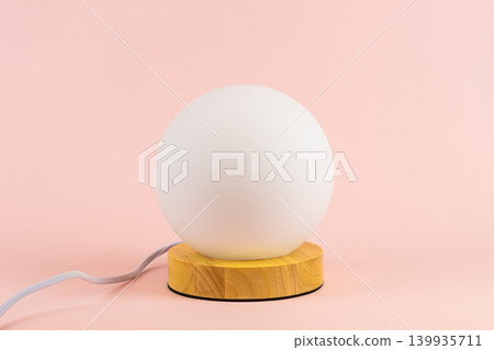 A glowing lamp on a pink background A glowing lamp on a pink background 139935711
