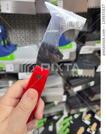 Handheld scraper tool displayed in a vibrant hardware store aisle Handheld scraper tool displayed in a vibrant hardware store aisle 139935837