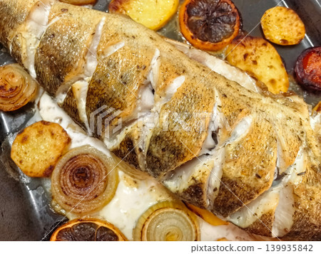 Delicious roasted fish with citrus and vegetables prepared for a family meal Delicious roasted fish with citrus and vegetables prepared for a family meal 139935842