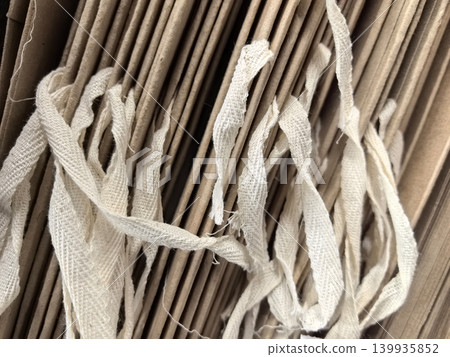 Layers of textured paper and strings create a captivating visual tapestry 139935852
