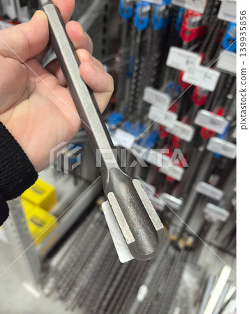 Precision tool held in hand at hardware store showcasing craftsmanship 139935856