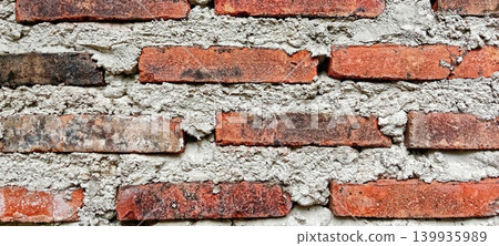 Rough red brick and cement wall texture Rough red brick and cement wall texture 139935989