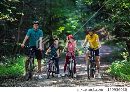 Active family enjoying biking adventure in scenic landscape. 139936086
