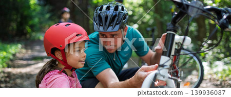 Father teaching daughter to check bicycle before ride for safety. Father teaching daughter to check bicycle before ride for safety. 139936087