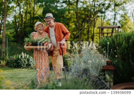 Senior couple working in garden during spring day. Senior couple working in garden during spring day. 139936099