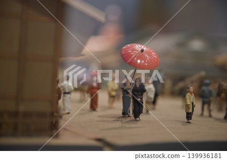 Miniatures depicting scenes of a medieval Japanese city. This instance shows a servant holding an umbrella or sunblocker for a noble lady. 139936181
