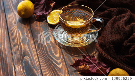 Hot tea with lemon on wooden table during autumn Hot tea with lemon on wooden table during autumn 139936239