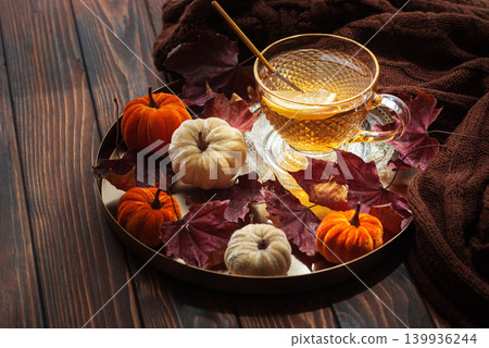 Hot tea with lemon on wooden table during autumn Hot tea with lemon on wooden table during autumn 139936244
