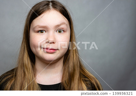 Close up portrait of a happy smiling teenage girl looking at the camera 139936321