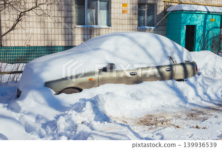 Car in the snow parked near the snow-covered road after a snowfall 139936539