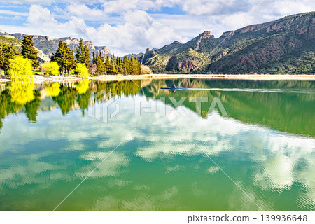 Man kayaking in the reservoir of the Sant Llorenc de Montgai Natural Park, Noguera region, Lleida, Catalonia. Nature, water sports. Man kayaking in the reservoir of the Sant Llorenc de Montgai Natural Park, Noguera region, Lleida, Catalonia. Nature, water sports. 139936648