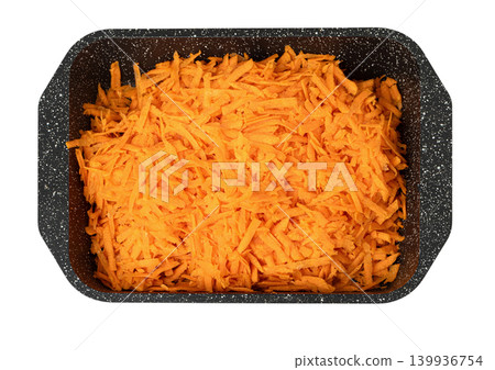 Shredded carrots filling a dark baking tray Shredded carrots filling a dark baking tray 139936754