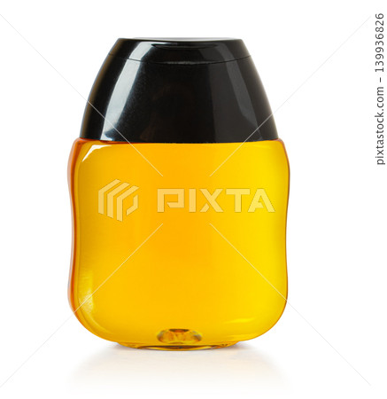 Golden honey dripping in plastic squeeze bottle with black cap Golden honey dripping in plastic squeeze bottle with black cap 139936826