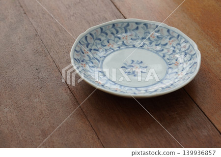 white and blue and orange ceramic plate on wooden floor background, decor, object, fashion, copy space white and blue and orange ceramic plate on wooden floor background, decor, object, fashion, copy space 139936857
