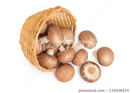 Brown champignon mushroom a wicker basket isolated on white background. Top view. Flat lay Brown champignon mushroom a wicker basket isolated on white background. Top view. Flat lay 139936874