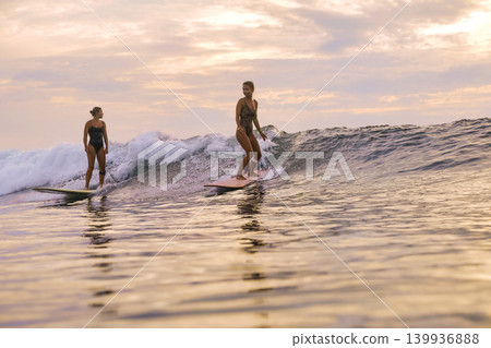 Evening Surfing Class Led By Instructor Emphasizing Support And Posture 139936888