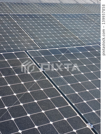 Solar panels cover rooftop with rows of photovoltaic cells and metal roof edge 139937858