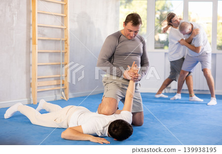 Judo lessons - young guy makes power throw during judo or sambo classes 139938195