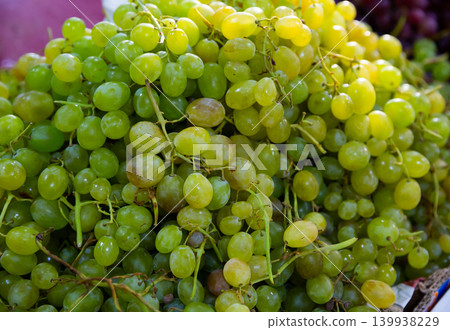 Ripe white grapes in clusters as background 139938229