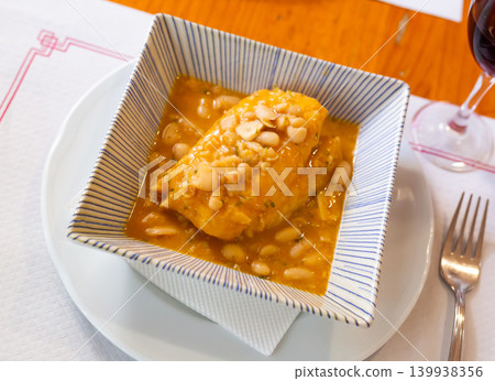 Large piece of lean cod fillet stewed in bean gravy 139938356