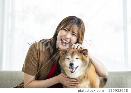 A Shiba Inu and a young woman looking at the camera A Shiba Inu and a young woman looking at the camera 139938638