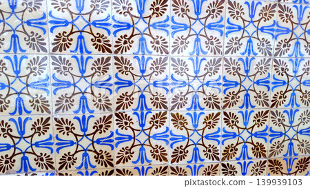 Traditional Portuguese Azulejo Tile Wall with Blue and Brown Floral Patterns 139939103