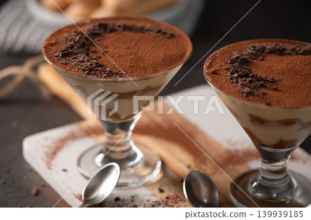Classic Italian Tiramisu Served in stemmed cocktail Glasses with Cocoa Powder and Chocolate Shavings Classic Italian Tiramisu Served in stemmed cocktail Glasses with Cocoa Powder and Chocolate Shavings 139939185