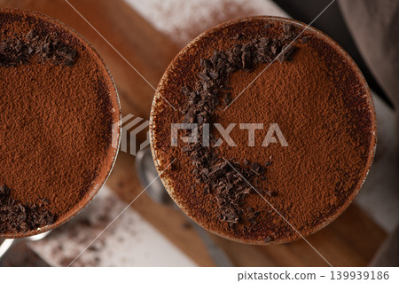 Top View of Tiramisu Desserts Dusted with Cocoa Powder and Dark Chocolate Shavings Top View of Tiramisu Desserts Dusted with Cocoa Powder and Dark Chocolate Shavings 139939186