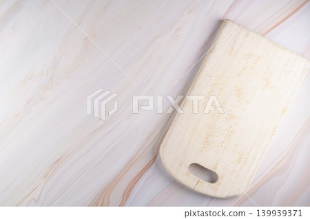 Wooden cutting board on a gray marble background Wooden cutting board on a gray marble background 139939371