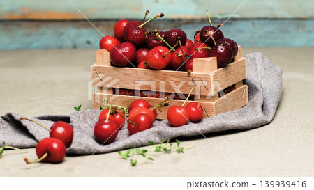 Red ripe cherries in small wooden box Red ripe cherries in small wooden box 139939416
