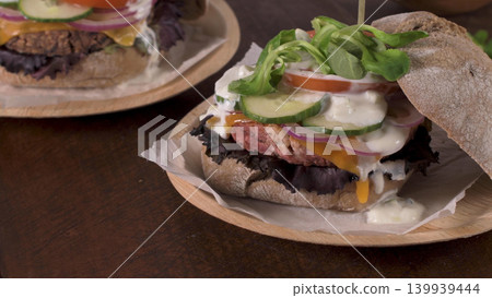 Healthy vegan burger with fresh vegetables and yogurt sauce Healthy vegan burger with fresh vegetables and yogurt sauce 139939444