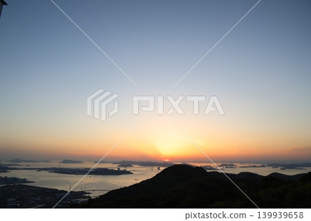 The Seto Ohashi Bridge at dusk and the sunset sky and setting sun over the Seto Inland Sea 6 The Seto Ohashi Bridge at dusk and the sunset sky and setting sun over the Seto Inland Sea 6 139939658