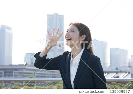 A career woman shouts her feelings towards the blue sky. A career woman shouts her feelings towards the blue sky. 139939927