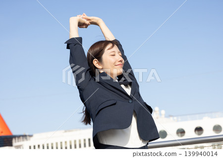 A woman in a suit is overjoyed and makes a victory pose. A woman in a suit is overjoyed and makes a victory pose. 139940014
