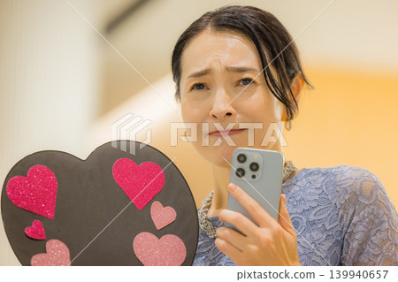 A middle-aged woman who finds happiness through her fan activities. A middle-aged woman who finds happiness through her fan activities. 139940657